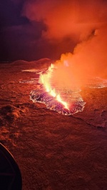 Billowing smoke and flowing lava turning the sky orange are seen in this Icelandic Department of Civil Protection and Emergency Management handout image during an volcanic eruption on the Reykjanes peninsula 3 km north of Grindavik, western Iceland on Dec