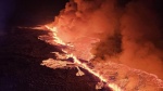 Billowing smoke and flowing lava turning the sky orange are seen in this Icelandic Department of Civil Protection and Emergency Management handout image during an volcanic eruption on the Reykjanes peninsula 3 km north of Grindavik, western Iceland on Dec