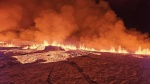 Billowing smoke and flowing lava turning the sky orange are seen in this Icelandic Department of Civil Protection and Emergency Management handout image during an volcanic eruption on the Reykjanes peninsula 3 km north of Grindavik, western Iceland on Dec