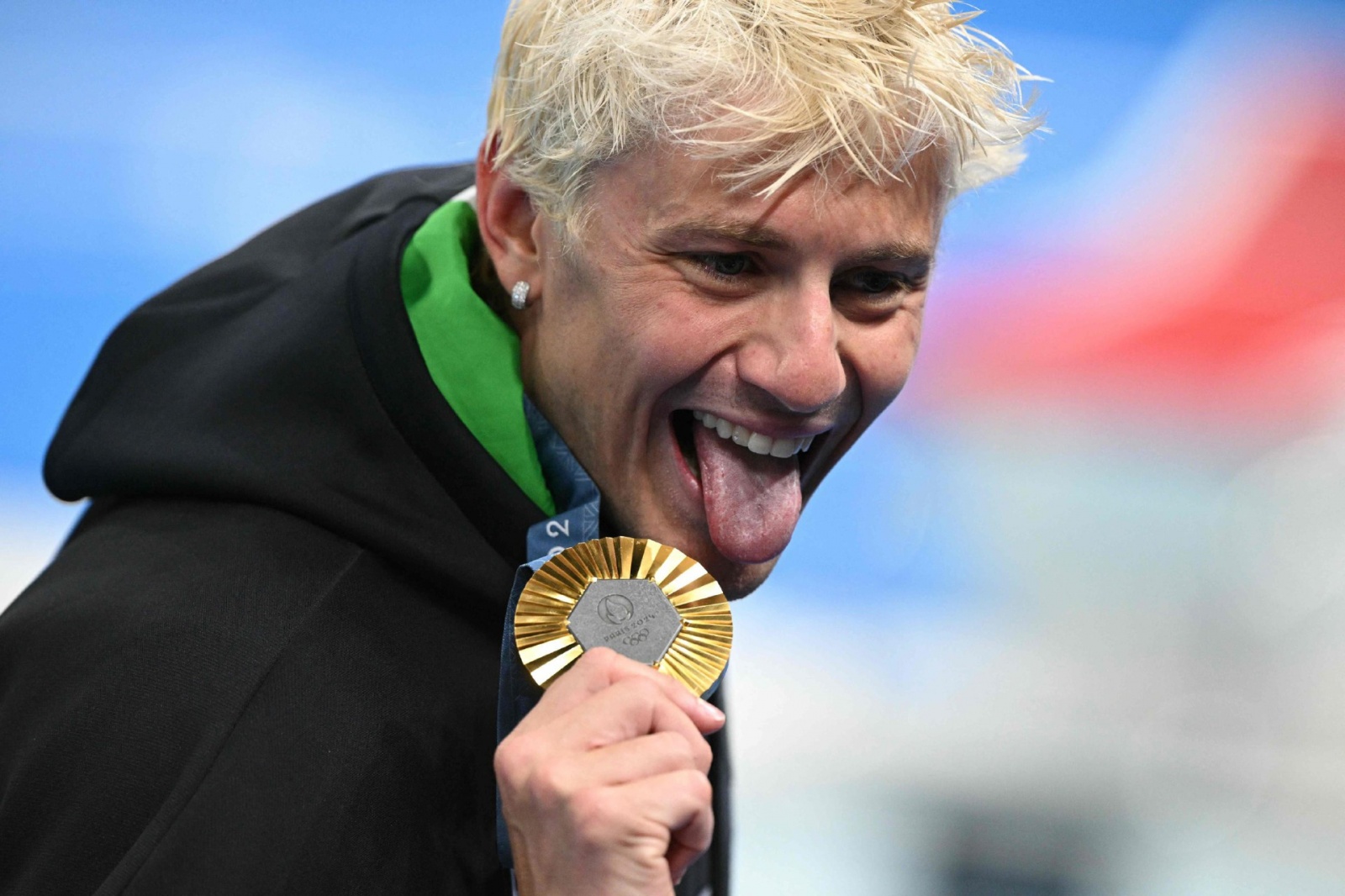 Gold medallist Italy's Nicolo Martinenghi celebrates after the men's 100m breaststroke swimming event during the Paris 2024 Olympic Games at the Paris La Defense Arena in Nanterre, west of Paris, on July 28, 2024. (Photo by Oli SCARFF / AFP)