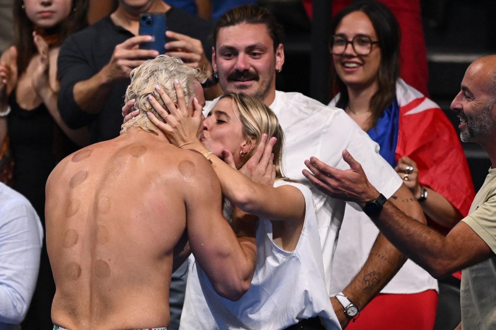 Italy's Nicolo Martinenghi celebrates after winning the final of the men's 100m breaststroke swimming event during the Paris 2024 Olympic Games at the Paris La Defense Arena in Nanterre, west of Paris, on July 28, 2024. (Photo by SEBASTIEN BOZON / AFP)