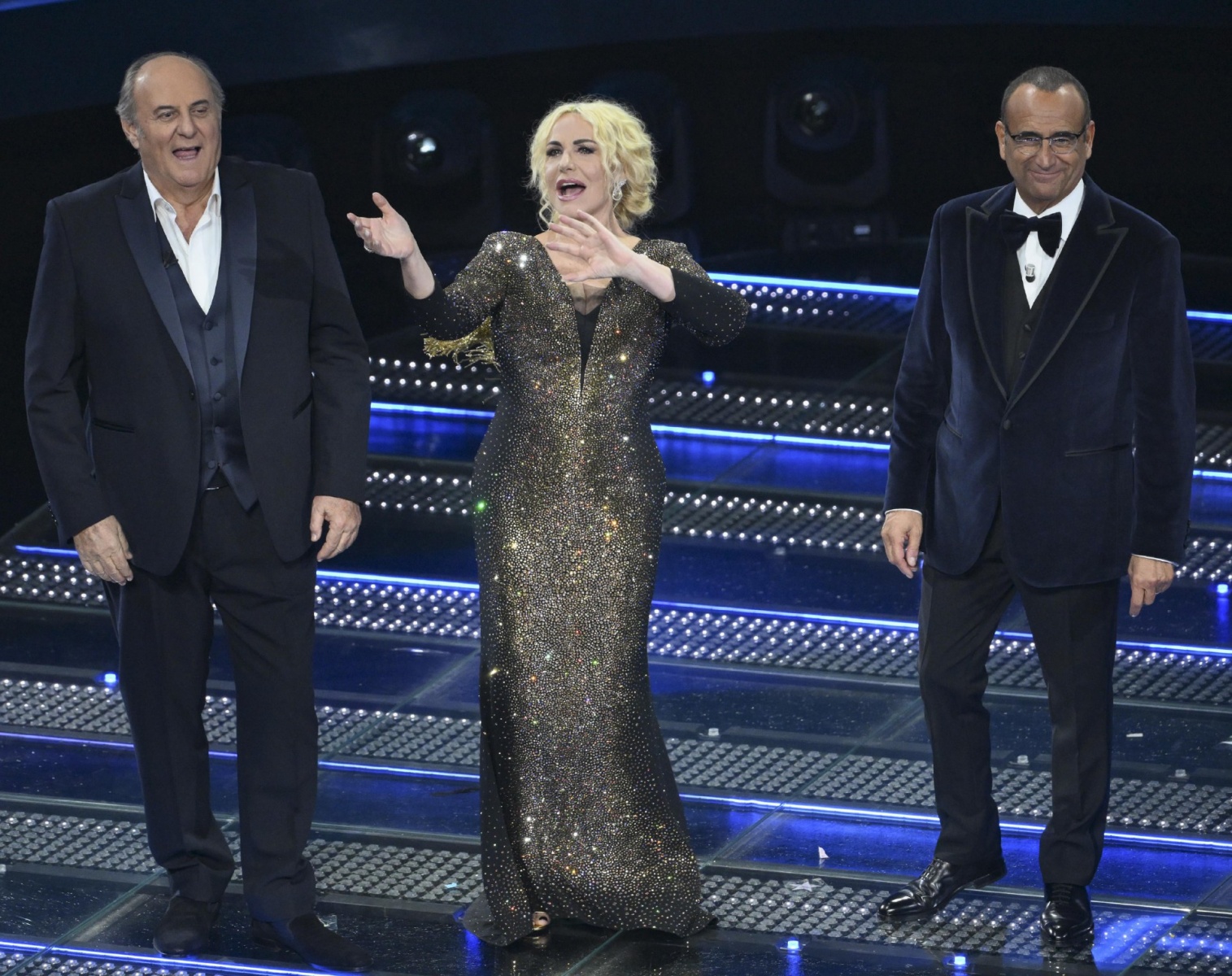 Sanremo Festival host and artistic director Carlo Conti (R) and Sanremo Festival co-host and Italian presenters Antonella Clerici (C) and Gerry Scotti on the stage of the Ariston theatre during the 75th edition of the Sanremo Italian Song Festival, in San